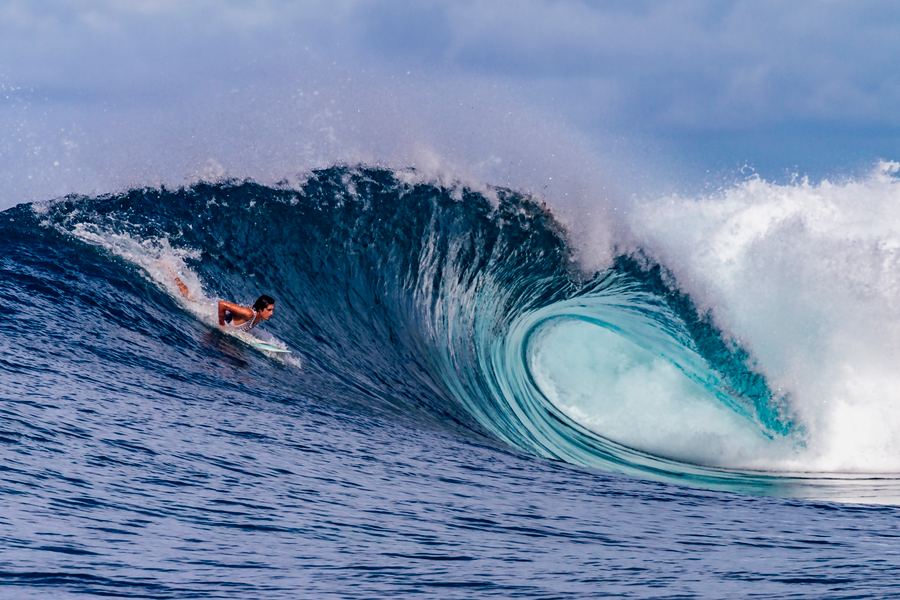 Surfer deep in a barrelling wave, Pacific Indonesia
