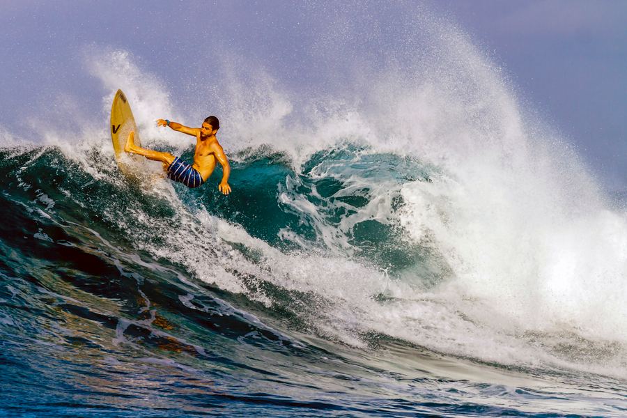 Surfer riding a breaking wave, Madagascar